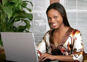 3111639-african-american-female-adult-working-at-a-laptop-computer-and-smiling1.jpg