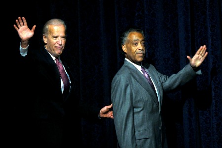 Vice President Joseph Biden, left and Rev. Al Sharpton wave to the audience as they arrive on stage at the National Action Network’s 11th annual convention in New York, Friday April 3, 2009. (AP Photo/Stephen Chernin)