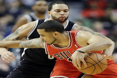 Brooklyn Nets guard Deron Williams, behind, tries to steal the ball from Chicago Bulls guard D.J. Augustin during the first half of an NBA basketball game in Chicago on Thursday, Feb. 13, 2014. (AP Photo/Nam Y. Huh)