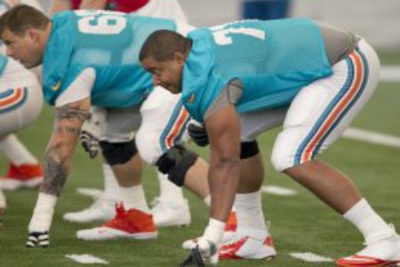 Tackle Jonathan Martin, right, in his stance before ball is snapped during Miami Dolphins practice at the Dolphins training facility at NSU in Davie, Florida, Tuesday, July 23, 2013. (Joe Rimkus Jr./Miami Herald/MCT via Getty Images)