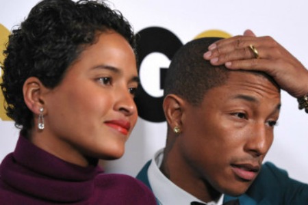 Helen Lasichanh, left, and Pharrell Williams arrive at the GQ "Men of the Year" event at The Ebell Theatre on Tuesday, Nov. 12, 2013 in Los Angeles. (Photo by John Shearer/Invision/AP) | John Shearer/Invision/AP