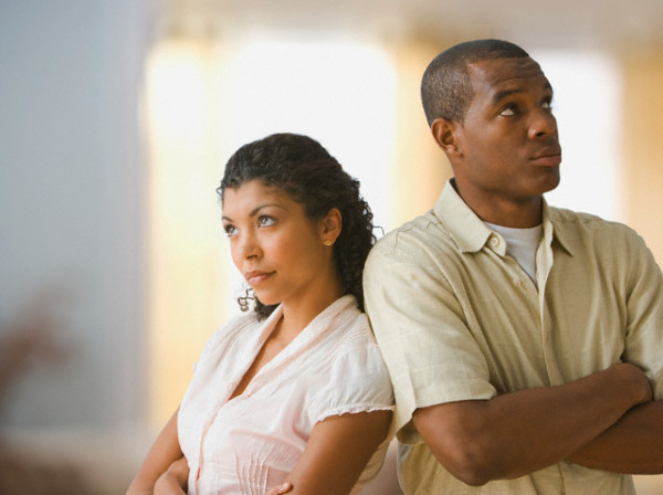 Angry African American couple standing back to back