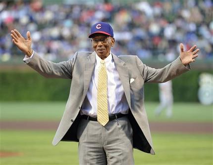FILE - Int his Aug. 13, 2013, file photl, former Chicago Cubs infielder Ernie Banks waves to the crowd before the Cubs' baseball game against the Cincinnati Reds in Chicago. Banks, the two-time MVP who never lost his boundless enthusiasm for baseball despite years of playing on losing Cubs teams, died Friday night, Jan. 23, 2015. He was 83. The Cubs announced Banks' death, but did not provide a cause. (AP Photo/Jim Prisching, File)