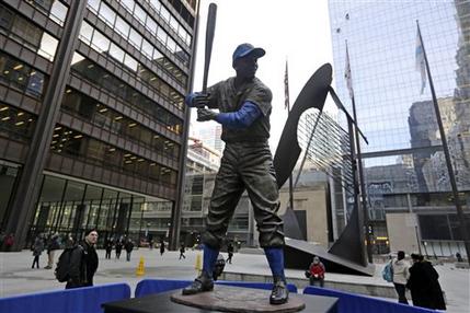 The statue of Chicago Cubs Hall of Famer Ernie Banks was placed next to the Picasso statue in Daley Plaza, as baseball fans get their first chance to pay their respects, Wednesday, Jan. 28, 2015, in Chicago. The city and the Cubs took the unprecedented step of taking the statue out of storage, where it was being held while the ballpark is renovated, and put it on public display away from its usual home at Wrigley Field. Banks died on Friday, Jan. 23, 2015. He was 83.(AP Photo/M. Spencer Green)
