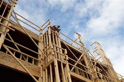 In this Jan. 12, 2015 photo, a builder works on a new apartment building under construction in Phoenix. (AP Photo/Ross D. Franklin)