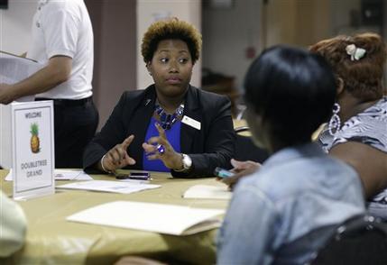 In this Friday, Jan. 23, 2015 photo, Natalie Parker, director of human resources at the Doubletree Grand, left, talks with job applicants during a job fair at the Hospitality Institute. On Thursday, Jan. 29, 2015, the U.S. Labor Department reports on the number of people who applied for unemployment benefits a week earlier. (AP Photo/Lynne Sladky)