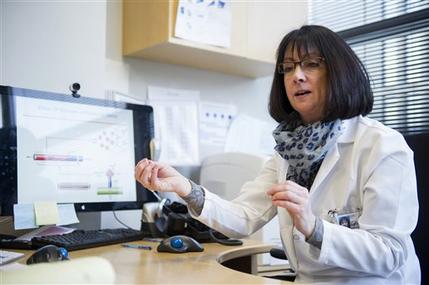 In this photo taken Feb. 4, 2015, Dr. Nancy Sullivan, chief, Biodefense Research Section, National Institute of Allergy and Infectious Diseases, speaks in her office at the Vaccine Research Center at the National Institutes of Health in Bethesda, Md. It took 16 years of twists and turns. Over and over, Dr. Nancy Sullivan thought she'd finally gotten her Ebola vaccine right, only to see the next experiment fail. But it was those failures that Sullivan credits for helping her unravel enough mysteries of the immune system to finally bring an Ebola vaccine to large-scale testing in Africa. She just hopes it was in time to prove if the shots really work. (AP Photo/Cliff Owen)