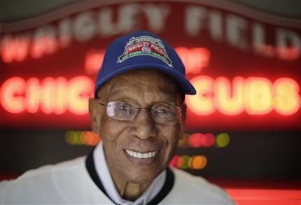 FILE - In this March 24, 2014 file photo, Chicago Cubs Hall of Fame slugger Ernie Banks smiles after an interview at the Cubs offices in Chicago. Banks died Jan. 23, 2015. Banks, who once said he wanted to have his ashes scattered at Wrigley Field, is at the center of a battle over his remains, with his estranged wife trying to prevent a longtime friend of Banks from having his remains cremated. (AP Photo/M. Spencer Green, File)