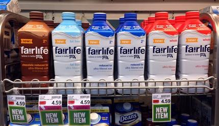 In this Friday, Jan. 23, 2015 photo, Fairlife milk products appear on display in the dairy section of an Indianapolis grocery store. Fairlife, which is rolling out nationally in coming weeks, is the product of a joint venture between Select Milk Producers, a dairy cooperative, and Coca-Cola. The product is filtered to have more protein and less sugar than regular milk. (AP Photo/Michael Conroy)