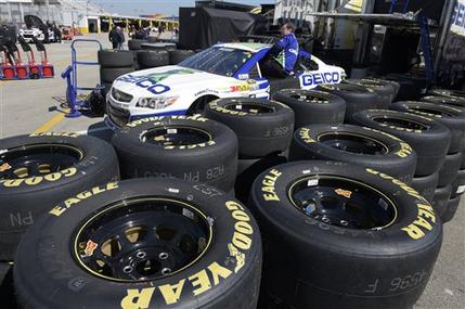 In this Feb. 14, 2015 photo, Goodyear tires surround the Casey Mears car in the garage area during a practice session for the Daytona 500 NASCAR Sprint Cup Series auto race at Daytona International Speedway, in Daytona Beach, Fla. The Goodyear Tire & Rubber Co. reports quarterly financial results on Tuesday, Feb. 17, 2015. (AP Photo/Phelan M. Ebenhack)