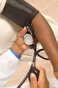 Doctor checking patient's blood pressure