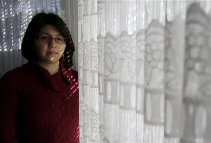 In this photo taken Feb. 19, 2015, Ariana Jimenez is seen in her home in Aurora, Ill. Young and healthy. Jimenez, 23, works part time as a nursing assistant at a community health center. The Supreme Court will hear arguments next week over whether millions of people covered by the nation’s health care law can legally continue to get financial help to pay for their insurance. If the court says no, millions of consumers across more than 30 states could lose federal subsidies for their premiums. (AP Photo/Nam Y. Huh) 