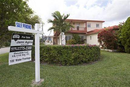 In this Thursday, Jan. 8, 2015 photo, a "sale pending" sign is posted atop a realty sign in front of a home in Surfside, Fla. The National Association of Realtors releases its January report on pending home sales, which are seen as a barometer of future purchases, on Friday, Feb. 27, 2015. (AP Photo/Wilfredo Lee)