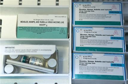 FILE - This Thursday, Jan. 29, 2015, file photo, shows boxes of the measles, mumps and rubella virus vaccine (MMR) and measles, mumps, rubella and varicella vaccine inside a freezer at a doctor's office in Northridge, Calif. While much of the attention in the ongoing measles outbreak has focused on student vaccination requirements and exemptions, less attention has been paid to another group in the nation’s classrooms: Teachers and staff members, who by and large are not required to be vaccinated. (AP Photo/Damian Dovarganes, File)