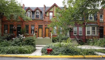 FILE - In this Aug. 22, 2014 file photo, the Pullman neighborhood’s ornate brick homes that were built in the 1800s by industrialist George Pullman as a blue-collar utopia to house workers from his sleeping-railcar factory in Chicago. President Barack Obama is designating three new national monuments for protection as historic or ecologically significant sites, including the Pullman neighborhood in Chicago where African-American railroad workers won a historic labor agreement. (AP Photo/Charles Rex Arbogast, File)