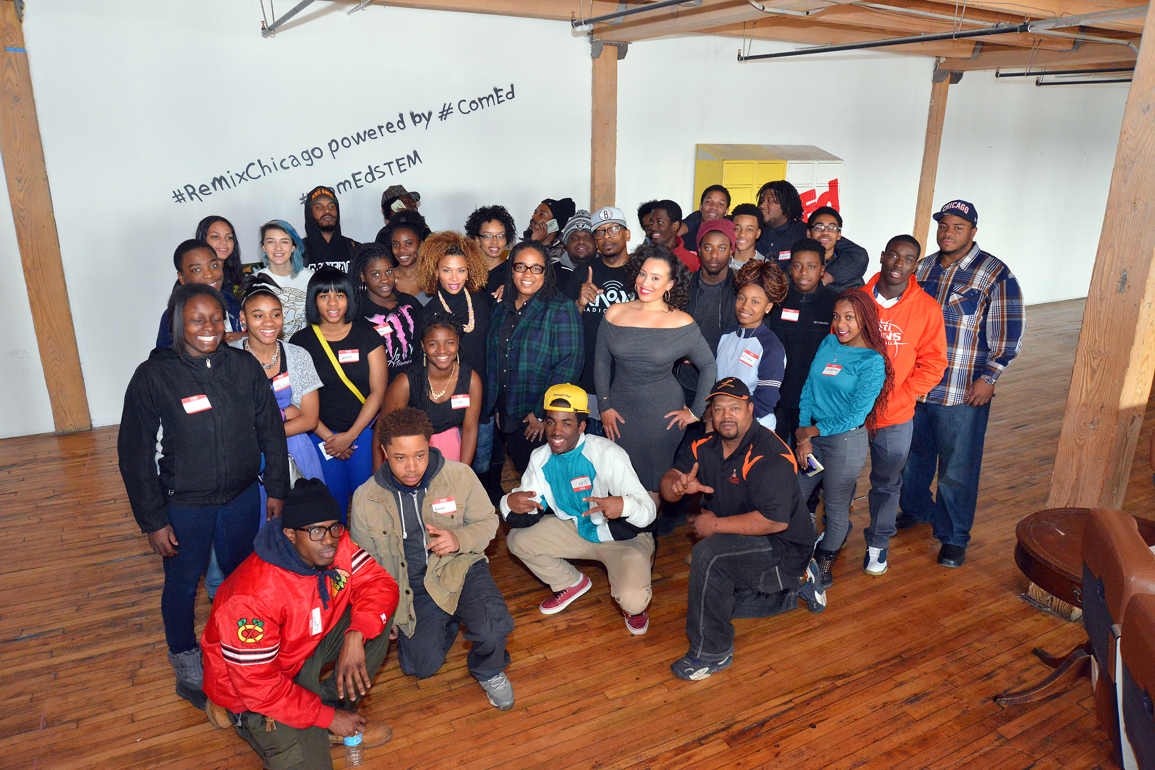 Guest panelists (center row) Consuela, V-103 on-air personality; Regina Williams, general manager internet radio station and DJ Niena Drake, entrepreneur, pose with Chicago-area teens participating in the "Power of Possibilities" one day boot camp exploring STEM (Science, Technology, Engineering, Math) and Entrepreneurship careers through the lens of the music industry.  The event was made possible by ComEd in partnership with The Remix Project Chicago.