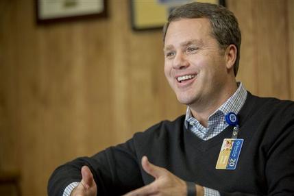 Wal-Mart President and Chief Executive Officer Doug McMillon speaks during an interview with The Associated Press on Tuesday, Feb. 17, 2015, in Bentonville, Ark. Wal-Mart Stores Inc. is spending $1 billion to change how it pays and trains hourly staff in a move it hopes will help reshape the image that it only offers dead-end jobs. (AP Photo/Gareth Patterson)