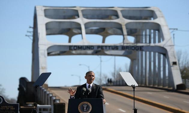 SELMA, AL - MARCH 07:  U.S. president Barack Obama speaks in front of the Edmund Pettus Bridge on March 7, 2015 in Selma, Alabama. Selma is commemorating the 50th anniversary of the famed civil rights march from Selma to Montgomery that resulted in a violent confrontation with Selma police and State Troopers on the Edmund Pettus Bridge on March 7, 1965.  (Photo by Justin Sullivan/Getty Images)