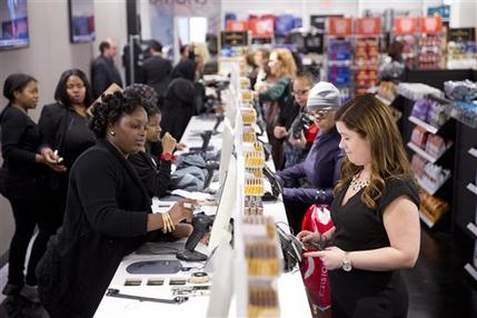 FILE - In this Oct. 28, 2014 file photo, shoppers check out at the Century 21 Department Store in Philadelphia. The Federal Reserve releases consumer credit data for January on Friday, March 6, 2015. (AP Photo/Matt Rourke, File)