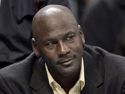 FILE - This is an April 16, 2014, file photo showing Charlotte Bobcats owner Michael Jordan watching during the first half of an NBA basketball game between the Bobcats and the Chicago Bulls in Charlotte, N.C. Michael Jordan and two other NBA owners have joined Forbes’ annual list of the world’s billionaires. Forbes said Monday, March 2, 2015, that Jordan’s net worth is estimated at $1 billion, thanks to his well-timed investment in the Charlotte Hornets. (AP Photo/Chuck Burton, File)
