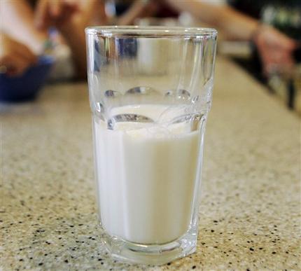 FILE - In this June 8, 2007 file photo, a glass of milk sits on the table in Montgomery, Ala. In an encouraging development for consumers worried about antibiotics in their milk, a new Food and Drug Administration study showed little evidence of drug contamination after surveying almost 2,000 dairy farms. In response to concerns, the agency in 2012 took samples of raw milk on the farms and tested them for 31 drugs. Results released by the agency Thursday show that less than 1 percent of the total samples showed any evidence of drug residue. (AP Photo/Rob Carr, File)