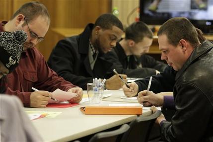 In this Jan. 29, 2015 photo, people fill out applications during a public safety job fair at City Hall in Saginaw, Mich. The U.S. Labor Department reports on the number of people who applied for unemployment benefits the week ending March 7, on Thursday, March 12, 2015. (AP Photo/The Saginaw News, David C. Bristow) 