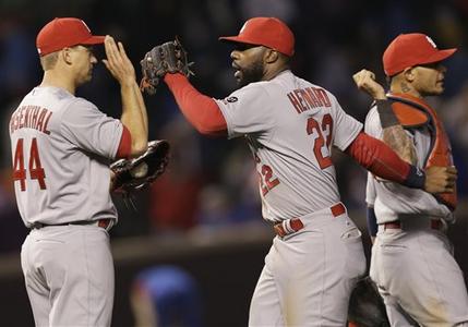  St. Louis Cardinals right fielder Jason Hayward, center, celebrates with closer Trevor Rosenthal, left, and catcher Yadier Molina after the St. Louis Cardinals defeated the Chicago Cubs 3-0 in a Major League Baseball season-opening game in Chicago, Sunday, April 5, 2015. (AP Photo/Nam Y. Hu