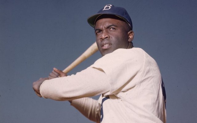 A portrait of Jackie Robinson with his bat