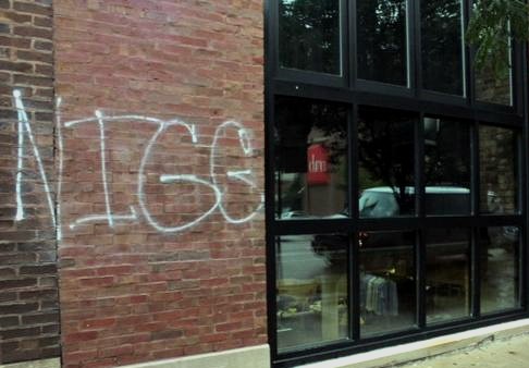 The word N*GG*R spray painted on the front of black owned business Nouveau Tavern in Chicago's River North neighborhood.