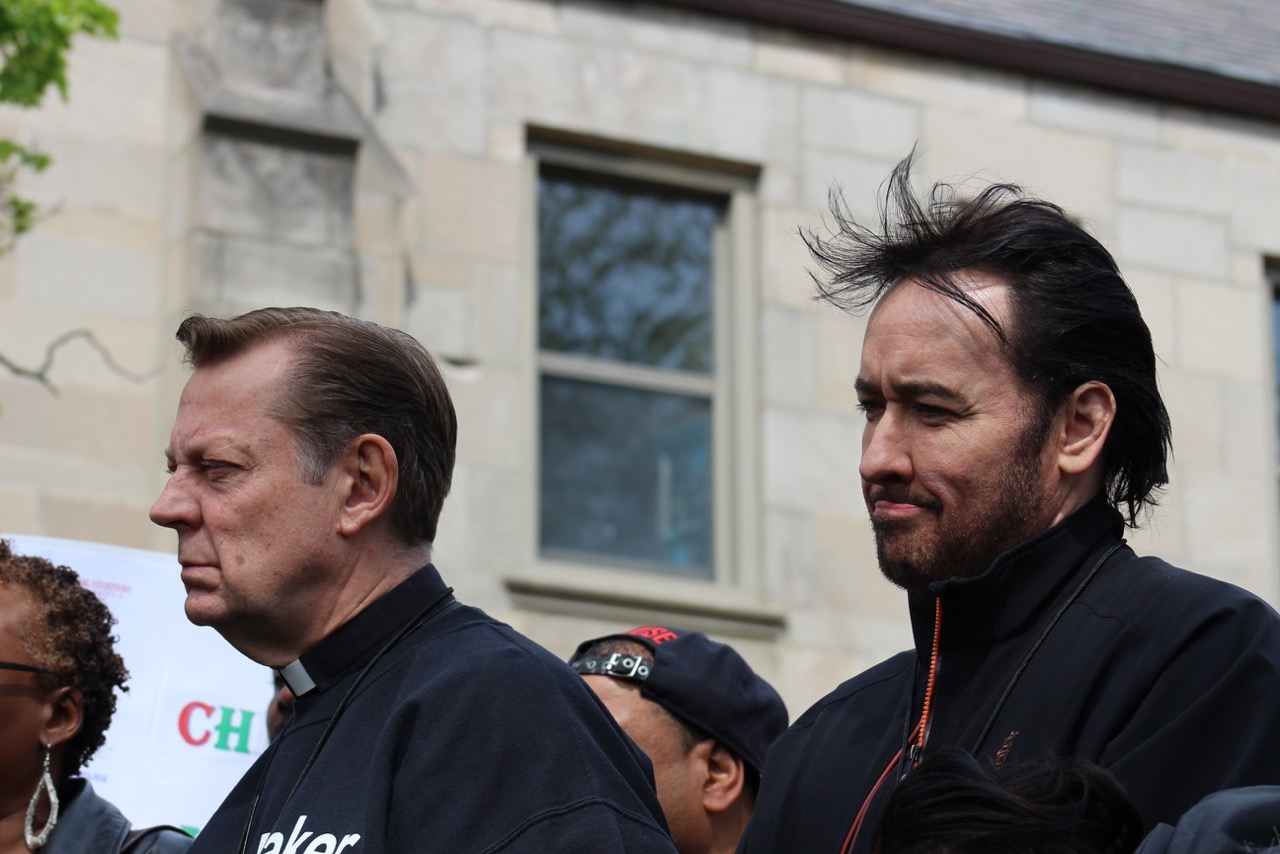 Father Pfleger and actor John Crusack in Chicago at Chi Raq rally