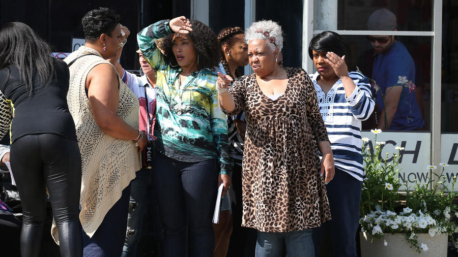 Actress Angela Bassett is in the center surrounded by other actresses on the Chiraq  filmset.