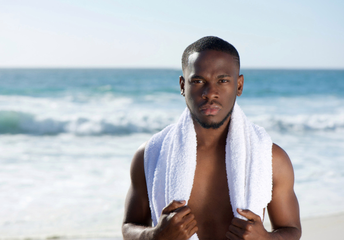 African American man embracing the sun on the beach