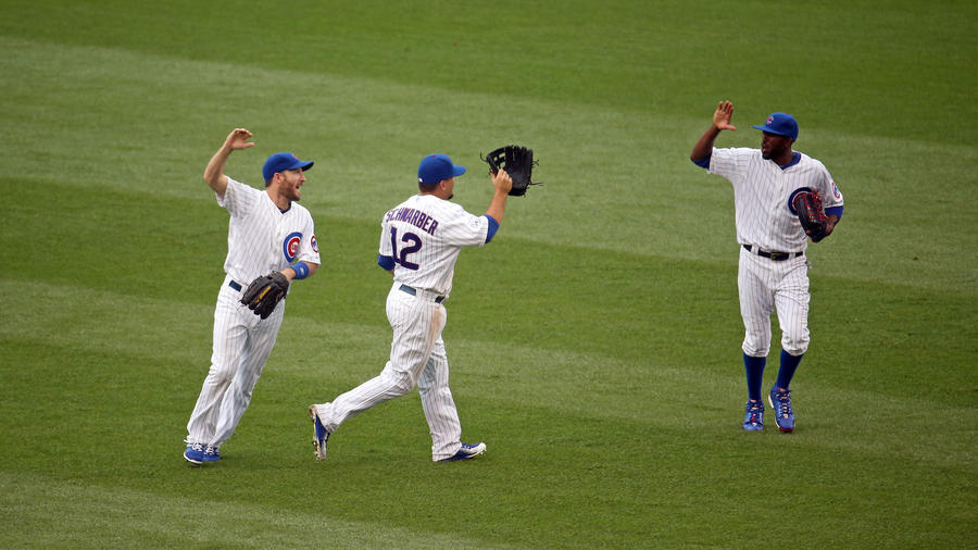Chris Denorfia, Kyle Schwarber and Dexter Fowler gesture 'high-five' in celebration of the win.