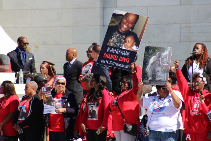 Families of slain victims hold up photos of loved ones at 20th Anniversary of Million Man March. Photo Credit: Mary L. Datcher