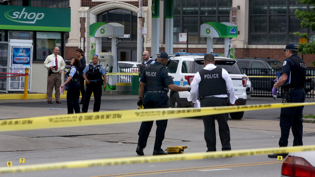 Police secure the crime scene at a a gas station in the 8600 block of South Ashland Avenue
