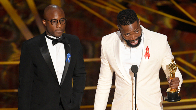 Barry Jenkins, left, and Tarell Alvin McCraney accept the award for best adapted screenplay for "Moonlight" at the Oscars on Sunday, Feb. 26, 2017, at the Dolby Theatre in Los Angeles. (Photo by Chris Pizzello/Invision/AP)