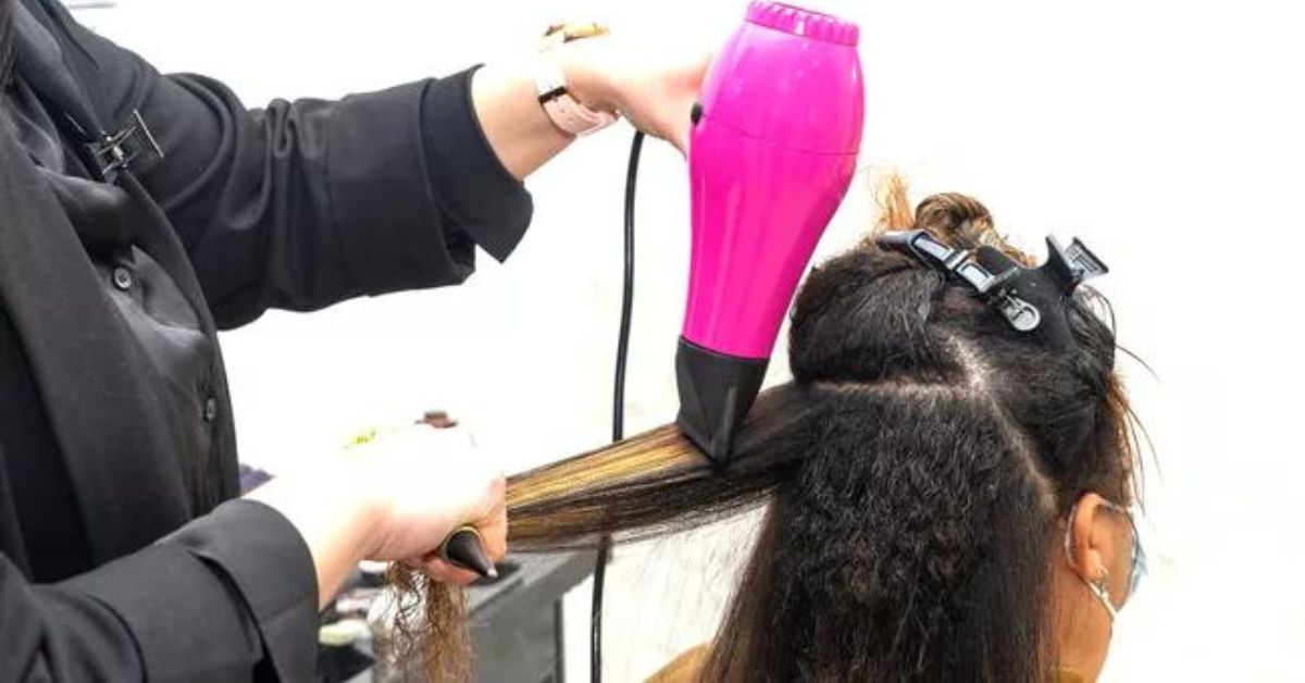 Girl gets her hair straightened.