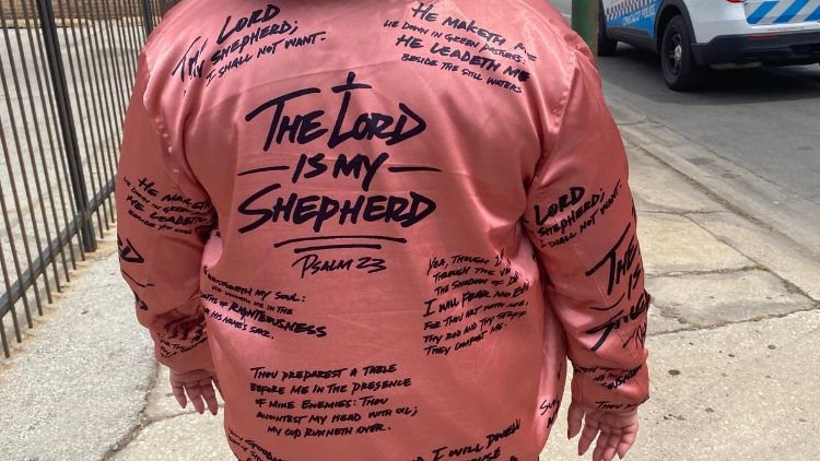 Woman marcher wears a jacket with Psalm 23 Bible verse