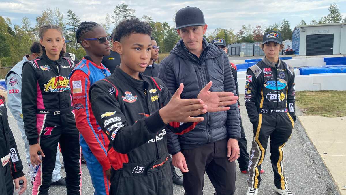 Drive for Diversity Combine participant Nathan Lyons discusses the mechanics of racing with his instructor, along with his peers
