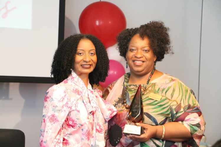 L-R Barbara Deer, executive director, Juneteenth Illinois accepting her caregiver award from the DMCC founder Wynona Redmond.