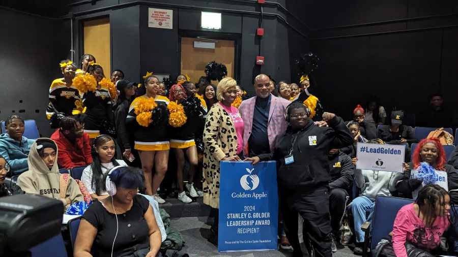 Martin Luther King College Prep Principal Brian Kelly celebrates his Golden Apple Award with students 