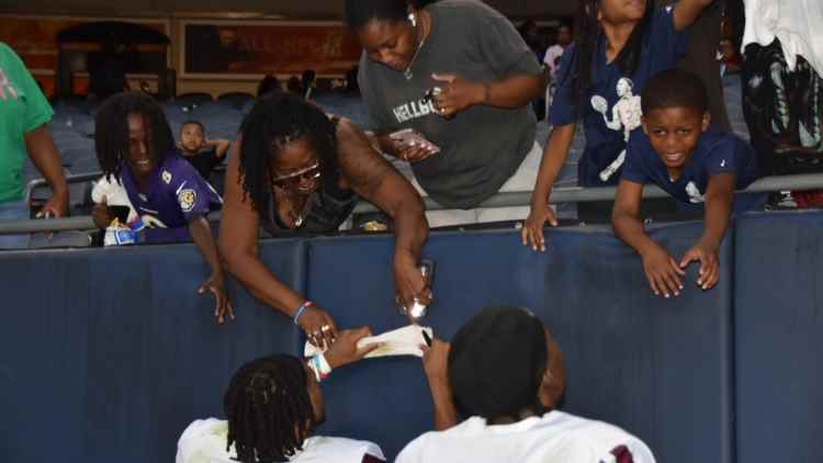 Morehouse Maroon Tigers players signing autographs after their win