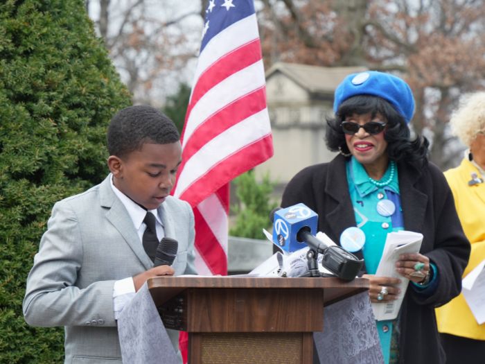 12-year-old King Hutchinson, a student at Burnside Scholastic Academy, delivers remarks at the wreath-laying ceremony